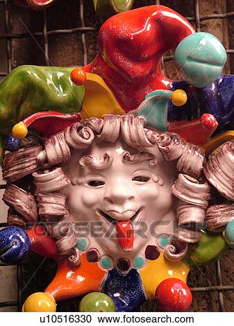 Stock Image -  Umbria, Italy, Orvieto, Europe, Ceramic pottery mask displayed outside a local shop in the medieval town of Orvieto.. Fotosearch