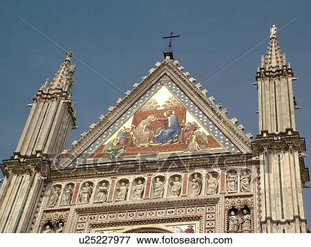 Stock Photo -  Umbria, Italy, Orvieto, Europe, Colorful mosaic and sculpture on the fatade of The Cathedral in the medieval town of Orvieto.. Fotosearch