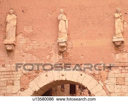 Stock Photograph -  Umbria, Italy, Spello, Europe. Fatade of the Medieval Porta Consolare the main entrance to the medieval town of Spello.. Fotosearch