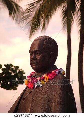 Waikiki, Honolulu, Oahu, HI, Hawaii, Kuhio Beach Park, Prince Kuhio Statue with leis around his neck, dressed in business suit, similar to what he wore as a delegate to Congress View Large Photo Image Stock Image - Waikiki, Honolulu, Oahu, HI, Hawaii, Kuhio Beach Park, Prince Kuhio Statue with leis around his neck, dressed in business suit, similar to what he wore as a delegate to Congress. Fotosearch