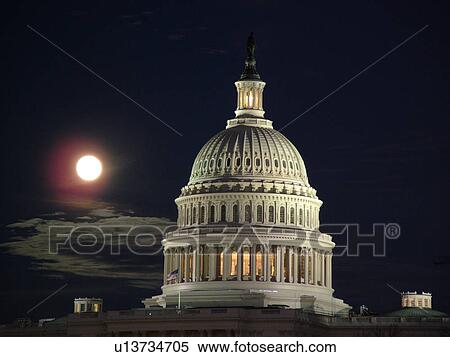 Stock Photography -  Washington, DC, District of Columbia, D. C United States Capitol Building on Capitol Hill in the nation's capital, full moon rising, evening. Fotosearch