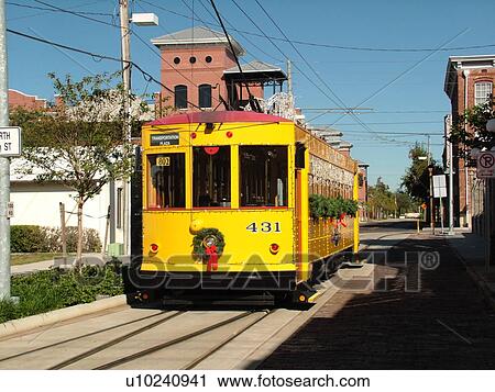 Stock Image -  Ybor City, FL, Florida, Tampa, Tampa Bay, Hillsborough Area Regional Transit, Tampa Bay Streetcar System, Teco Line, yellow streetcar, decorated for Christmas holidays. Fotosearch