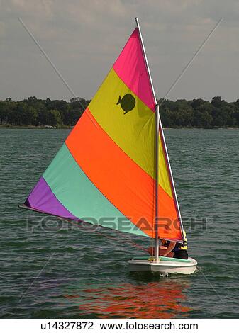 Stock Image -  Alexandria, MN, Minnesota, Maple Lake, couple sailing, sunfish, sailboat. Fotosearch