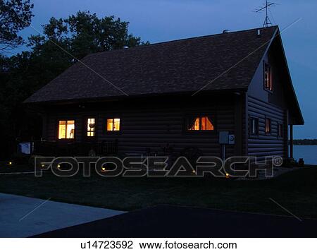 Stock Image -  Alexandria, MN, Minnesota, Maple Lake, log cabin, home, evening. Fotosearch