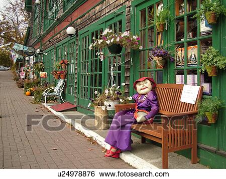 Stock Photograph -  Bar Harbor, ME, Maine, Mount Desert Island, Downtown, shops and restaurants, fall decorations, scarecrow woman sitting on a bench. Fotosearch