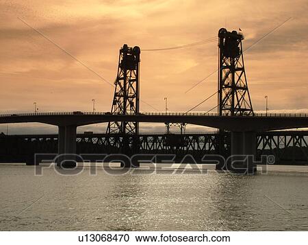 Stock Image -  Bath, ME, Maine, Kennebec River, bridge, sunrise. Fotosearch