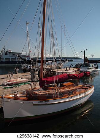 Stock Image -  Bayfield, WI, Wisconsin, Lake Superior, marina, harbor, wooden sailboat, dock. Fotosearch