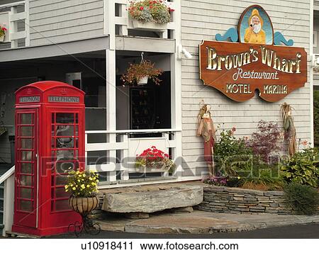 Stock Image -  Booth Bay Harbor, ME, Maine, fishing village, Brown's Wharf, Brown's Wharf Restaurant and Marina, red telephone booth. Fotosearch