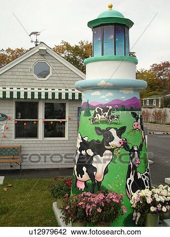 Stock Image -  Booth Bay Harbor, ME, Maine, fishing village, shops, cows painted on a lighthouse. Fotosearch
