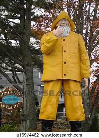 Booth Bay Harbor, ME, Maine, fishing village, Brown's Wharf, statue of a fisherman in a yellow rainsuit outside Brown's Wharf Restaurant and Marina View Large Photo Image Stock Image - Booth Bay Harbor, ME, Maine, fishing village, Brown's Wharf, statue of a fisherman in a yellow rainsuit outside Brown's Wharf Restaurant and Marina. Fotosearch