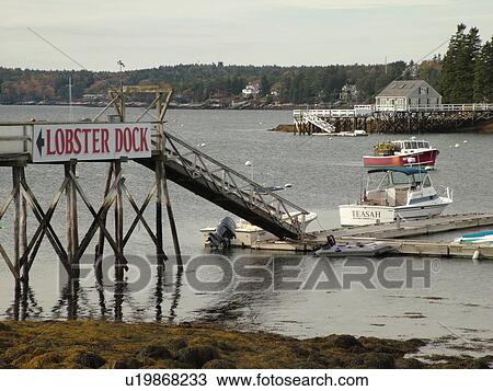 Stock Image -  Booth Bay Harbor, ME, Maine, fishing village, boats, dock, low tide. Fotosearch