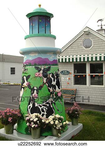 Stock Image -  Booth Bay Harbor, ME, Maine, fishing village, shops, cows painted on a lighthouse. Fotosearch