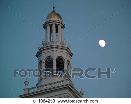 Stock Image -  Burlington, VT, Vermont, Ira Allen Chapel, steeple, moonrise, evening. Fotosearch