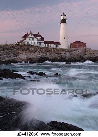 Stock Image -  Cape Elizabeth, ME, Maine, Portland Head Light Lighthouse, Fort Williams Park, sunset, waves crashing against the rocky coastline. Fotosearch