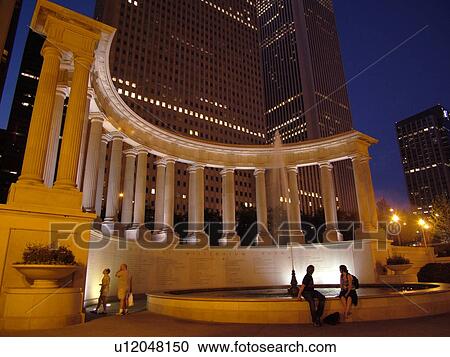Stock Image -  Chicago, IL, Illinois, Windy City, Downtown, skyline, Millennium Park, Wrigley Square, Millennium Monument, semi-circular row of peristyle columns, evening, reflecting pool and fountain. Fotosearch