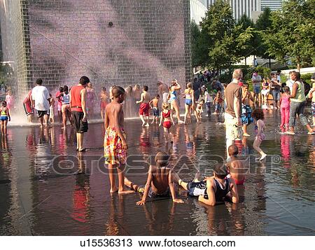 Stock Image -  Chicago, IL, Illinois, Windy City, Downtown, Millennium Park, Crown Fountain, people cooling off, hot summer day. Fotosearch