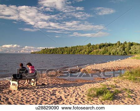 Cornucopia WI, Wisconsin, Lake Superior, beach, couple sitting on a bench View Large Photo Image Stock Image -  Cornucopia WI, Wisconsin, Lake Superior, beach, couple sitting on a bench. Fotosearch