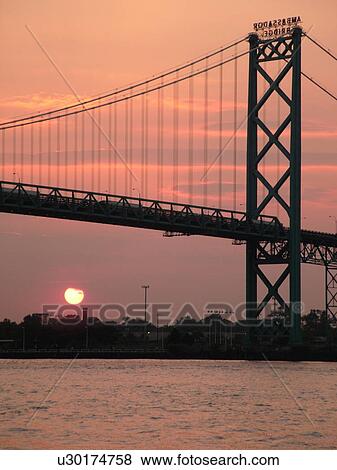 Stock Photo -  Detroit, MI, Michigan, Detroit River, Windsor, Ontario, Canada, Ambassador Bridge, sunset. Fotosearch