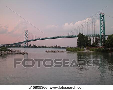 Stock Photograph -  Detroit, MI, Michigan, Detroit River, Windsor, Ontario, Canada, Ambassador Bridge, evening. Fotosearch