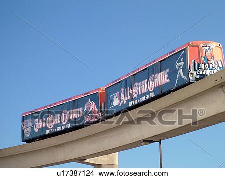 Picture -  Detroit, MI, Michigan, Motor City, Downtown, Detroit People Mover, aerial trolley, elevated light-rail system, All Star Baseball Game advertisement. Fotosearch