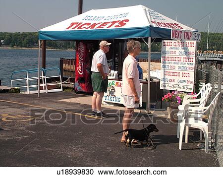 Stock Image -  Gills Rock, WI, Wisconsin, Door Peninsula, Green Bay, ticket sales, passenger ferry to Washington Island, senior couple waiting to buy tickets. Fotosearch