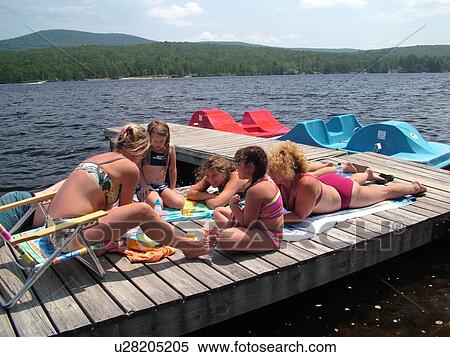 Groton, VT, Vermont, Lake Groton, Groton State Forest, Mothers and daughters playing on a dock, recreation, sun tanning, bathing suits View Large Photo Image Stock Photography - Groton, VT, Vermont, Lake Groton, Groton State Forest, Mothers and daughters playing on a dock, recreation, sun tanning, bathing suits. Fotosearch