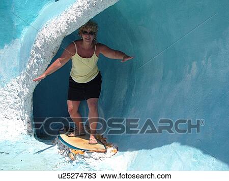 Stock Image -  Kalaheo, Kauai, HI, Hawaii, South Shore, Gift shop, attraction, riding a wave. Fotosearch