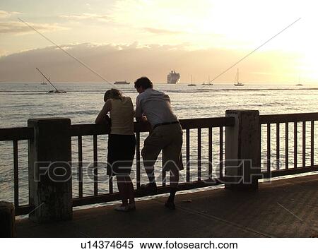 Lahaina, Maui, HI, Hawaii, West Maui, Lahaina Harbor, young couple standing on a terrace on the waterfront at sunset View Large Photo Image Stock Photography - Lahaina, Maui, HI, Hawaii, West Maui, Lahaina Harbor, young couple standing on a terrace on the waterfront at sunset. Fotosearch