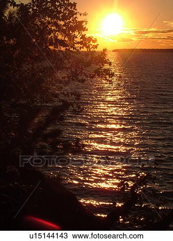 Stock Image -  Little Sandy Bay, WI, Wisconsin, Lake Superior, sunset. Fotosearch