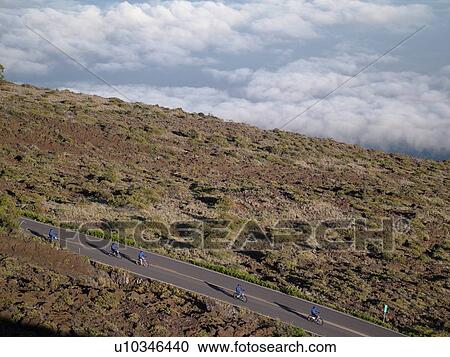 Stock Image -  Maui, HI, Hawaii, Haleakala National Park, Haleakala Crater Road, bike down a volcano. Fotosearch