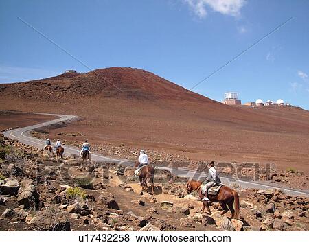 Stock Photo -  Maui, HI, Hawaii, Haleakala National Park, horseback riding on the volcano. Fotosearch