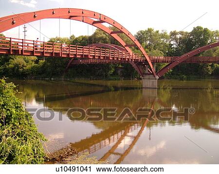 Stock Image -  Midland, MI, Michigan, The Tridge, three-legged pedestrian bridge crosses the Tittabawasee and Chippewa Rivers. Fotosearch