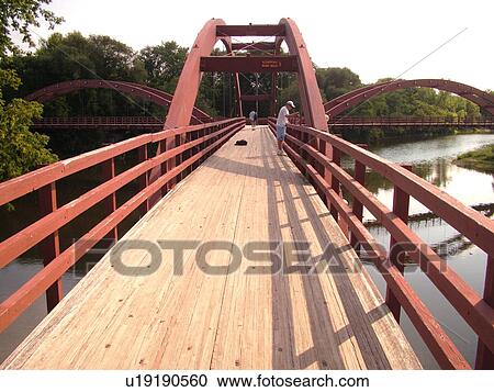 Stock Image -  Midland, MI, Michigan, The Tridge, three-legged pedestrian bridge crosses the Tittabawasee and Chippewa Rivers. Fotosearch