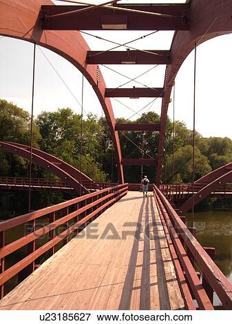 Stock Photo -  Midland, MI, Michigan, The Tridge, three-legged pedestrian bridge crosses the Tittabawasee and Chippewa Rivers. Fotosearch