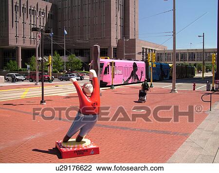 Stock Image -  Minneapolis, MN, Minnesota, Twin Cities, Downtown, Government Plaza, Metro Transit, light rail, tram, IPOD advertising, Forever Five statue. Fotosearch