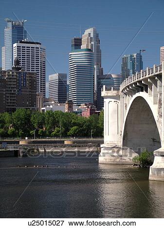 Stock Photo -  Minneapolis, MN, Minnesota, Twin Cities, Downtown skyline, Mississippi River, Third Avenue Bridge. Fotosearch