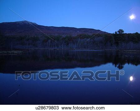 Stock Image -  Monadnock State Park, NH, New Hampshire, Pond, Mt. Monadnock, evening, moon. Fotosearch