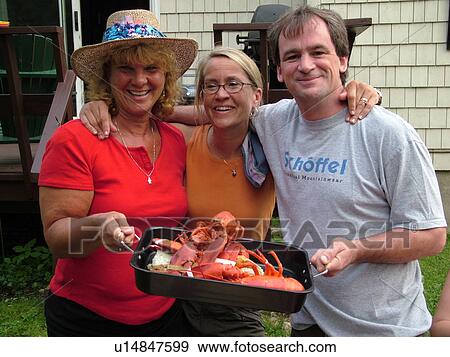 Stock Photo -  Montpelier, VT, Vermont, boiled lobster, picnic, adult friends, 3, fourth of July. Fotosearch