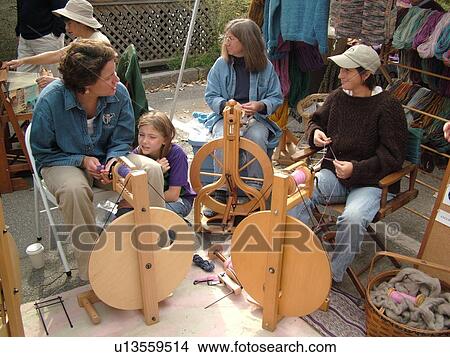 Picture -  Montpelier, VT, Vermont, Farmer's Market, spinning wool, spin wheel. Fotosearch