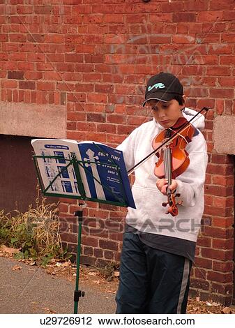 Stock Image -  Montpelier, VT, Vermont, Farmer's Market, street musician playing for tips (money). Fotosearch