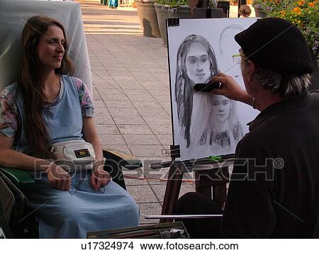 Picture -  Montreal, Canada, QC, Quebec, Old Port, Old Montreal, Place Jacques Cartier, street artist sketching a woman's portrait. Fotosearch