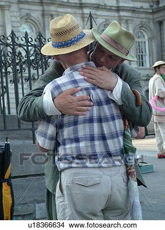 Picture -  Montreal, Canada, QC, Quebec, Old Port, Old Montreal, Place Jacques Cartier, street artist, mime hugging man. Fotosearch