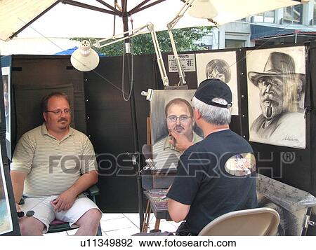 Stock Image -  Montreal, Canada, QC, Quebec, Old Port, Old Montreal, Place Jacques Cartier, street artist sketching a man's portrait. Fotosearch