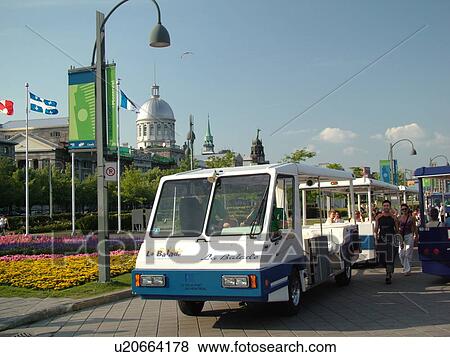 Stock Photo -  Montreal, Canada, QC, Quebec, Old Port, Old Montreal, Bonsecours Market (Marche Bonsecours), waterfront, riverwalk, free sightseeing shuttle, (La Balade) ride. Fotosearch