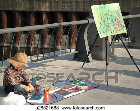 Stock Photo -  Montreal, Canada, QC, Quebec, Old Port, Old Montreal, waterfront, riverwalk, street artist. Fotosearch