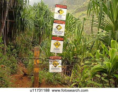 Stock Photo -  Napali Coast, Kauai, HI, Hawaii, North Shore, Na Pali, Kalalau Trail, Hanakapiai Valley, warning signs. Fotosearch
