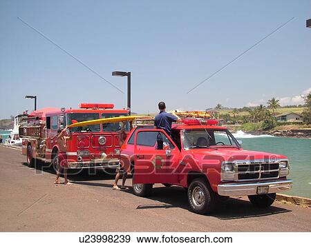 Stock Photo -  Poipu, Kauai, HI, Hawaii, South Shore, Kukuiula Harbor, Fire Truck, rescue squad, surfboard. Fotosearch