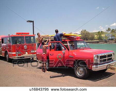 Stock Photography -  Poipu, Kauai, HI, Hawaii, South Shore, Kukuiula Harbor, Fire Truck, rescue squad, surfboard. Fotosearch