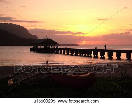 Stock Photography -  Princeville, Kauai, HI, Hawaii, North Shore, Hanalei Bay, Black Pot Beach Park, Hanalei Beach Park, sunset, pier, jetty. Fotosearch
