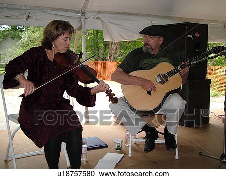 Stock Image -  Randolph, VT, Vermont, New World Festival, musicians playing violin and guitar. Fotosearch